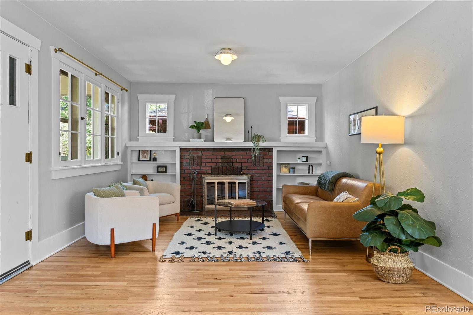 2314 Grape Street Denver, CO 80207 - Photo 7 of 49 a living room with furniture and a fireplace