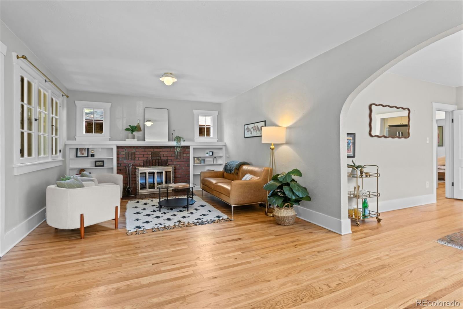 2314 Grape Street Denver, CO 80207 - Photo 8 of 49 a living room with furniture and a fireplace