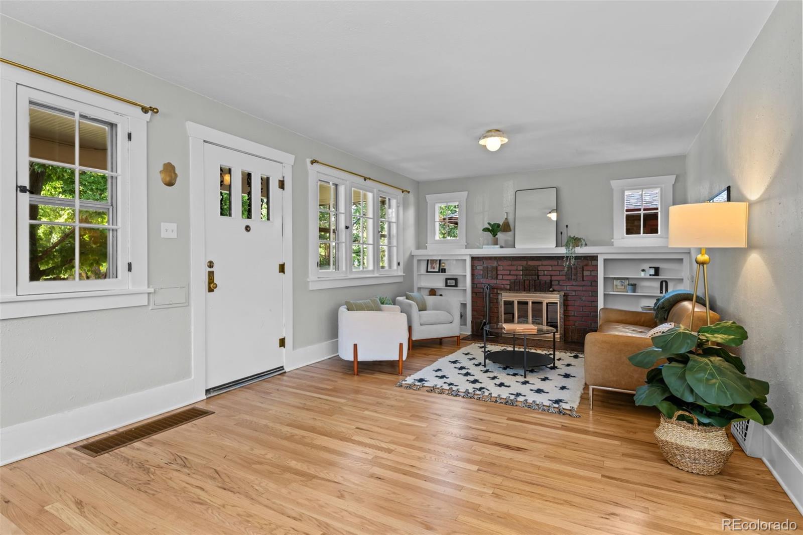 2314 Grape Street Denver, CO 80207 - Photo 9 of 49 a living room with furniture and a fireplace