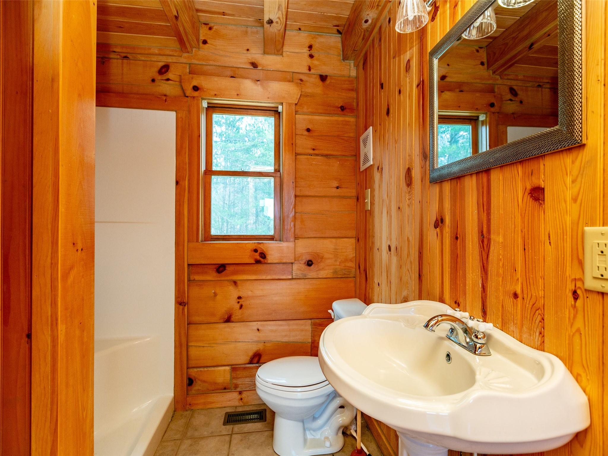 527 Laughter Road Mill Spring, NC 28756 - Photo 7 of 14 a bathroom with a sink and a toilet