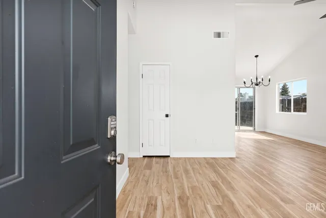 a view of a room with wooden floor and window