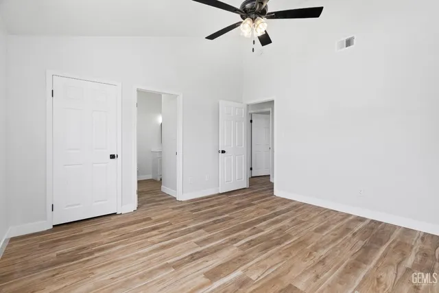 a view of a room with wooden floor and white walls