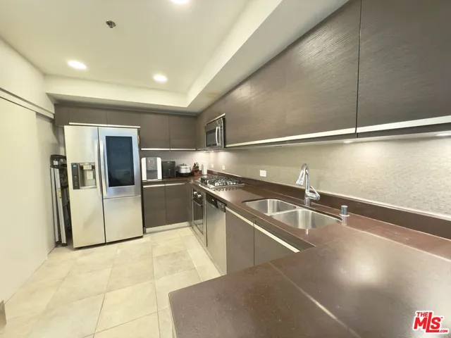 a spacious bedroom with a bed and a chandelier