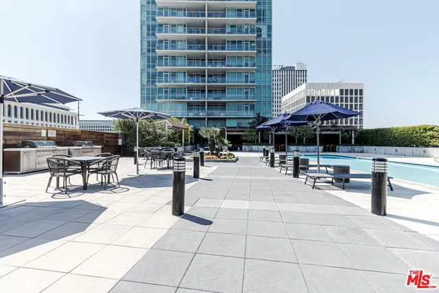 a living room with furniture large window and wooden floor