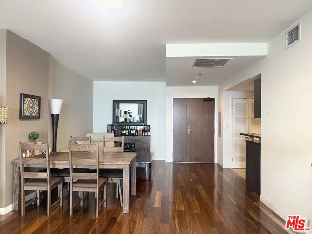 a dining room with furniture and wooden floor
