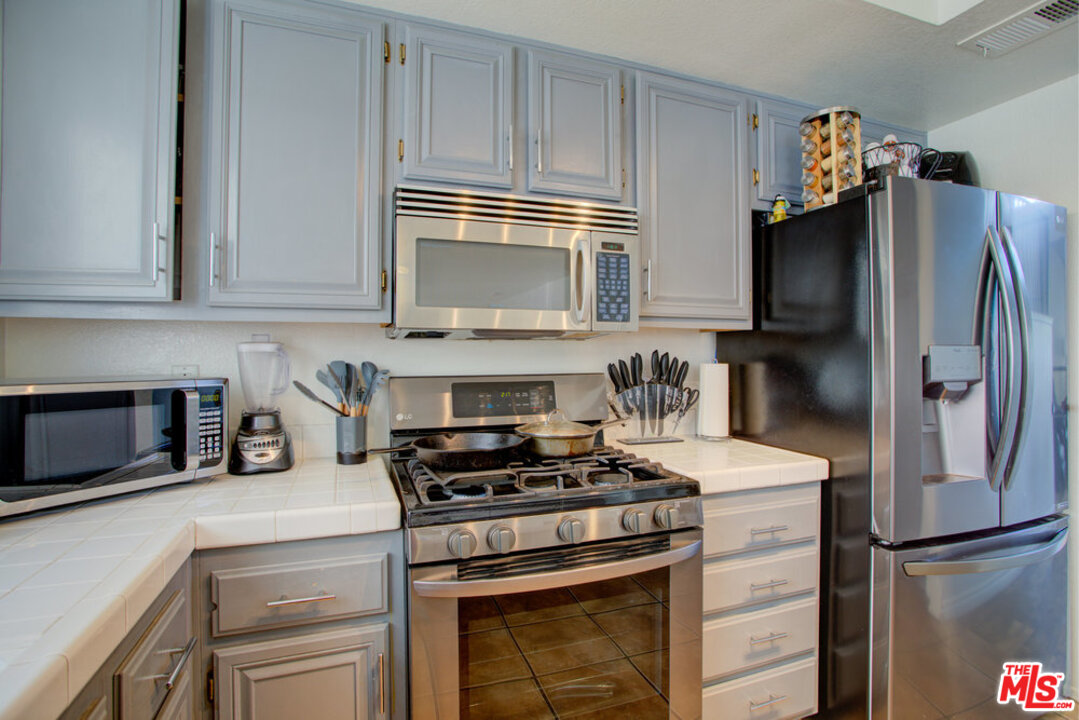 19281 Foxtail Lane Riverside, CA 92508 - Photo 19 of 53 a kitchen with stainless steel appliances a refrigerator stove and microwave