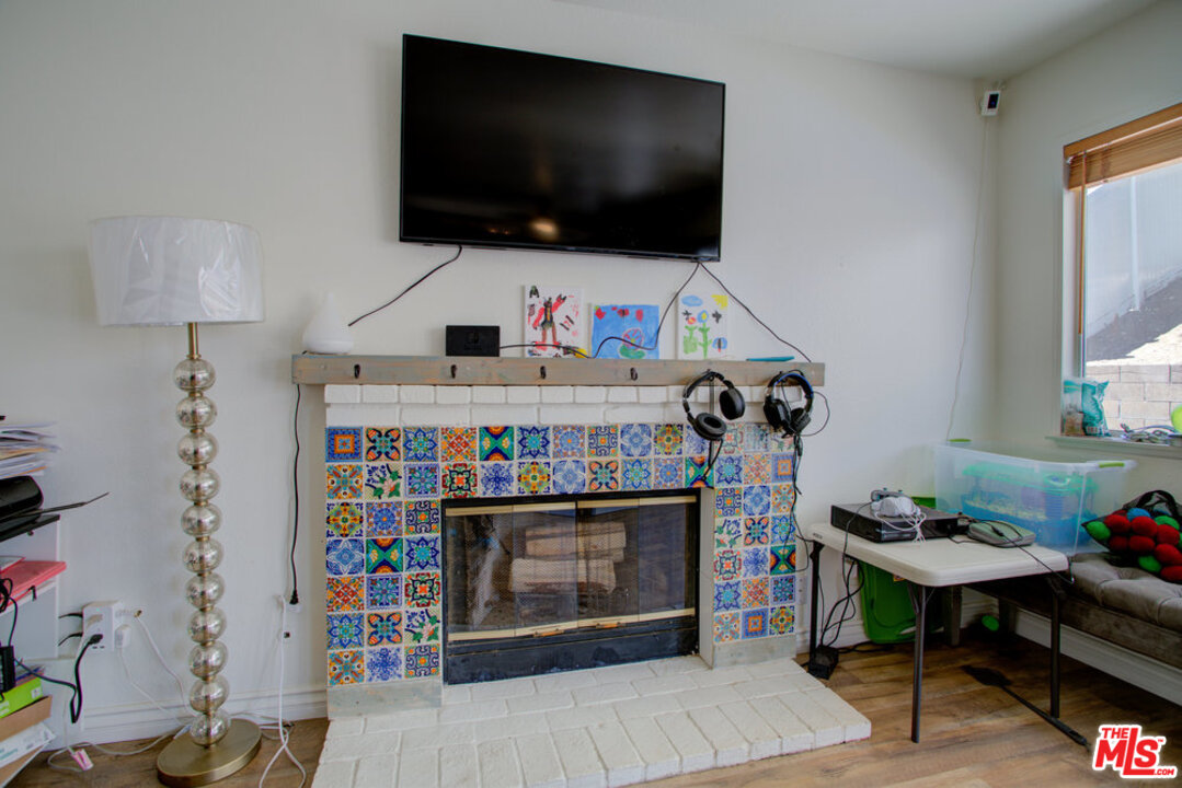 19281 Foxtail Lane Riverside, CA 92508 - Photo 24 of 53 a living room with furniture a flat screen tv and a fireplace