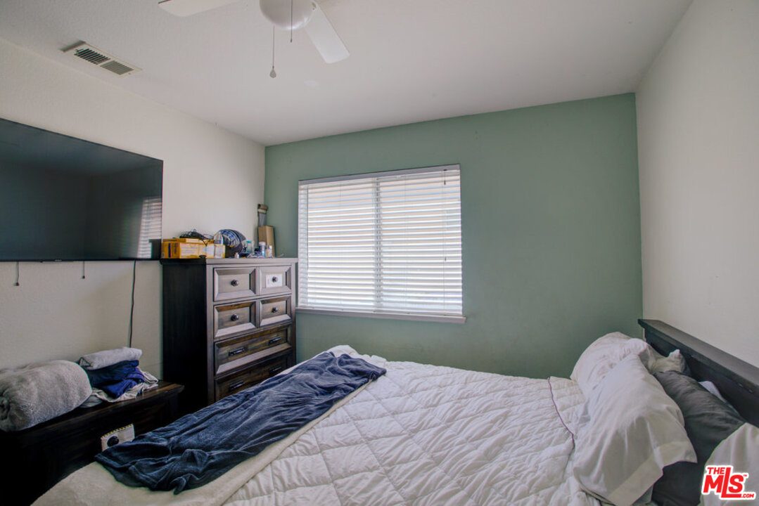 19281 Foxtail Lane Riverside, CA 92508 - Photo 27 of 53 a bedroom with a bed and a flat screen tv
