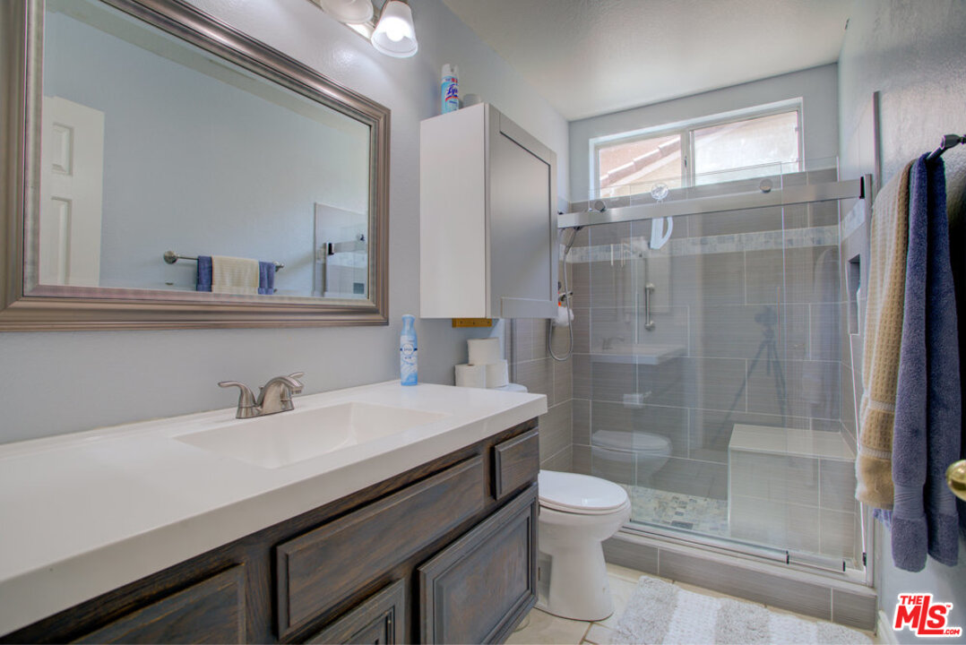 19281 Foxtail Lane Riverside, CA 92508 - Photo 30 of 53 a bathroom with a sink a toilet and shower