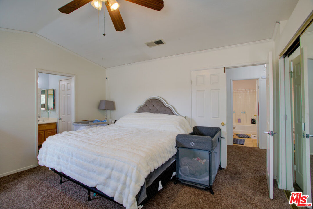 19281 Foxtail Lane Riverside, CA 92508 - Photo 33 of 53 a bedroom with a bed and ceiling fan