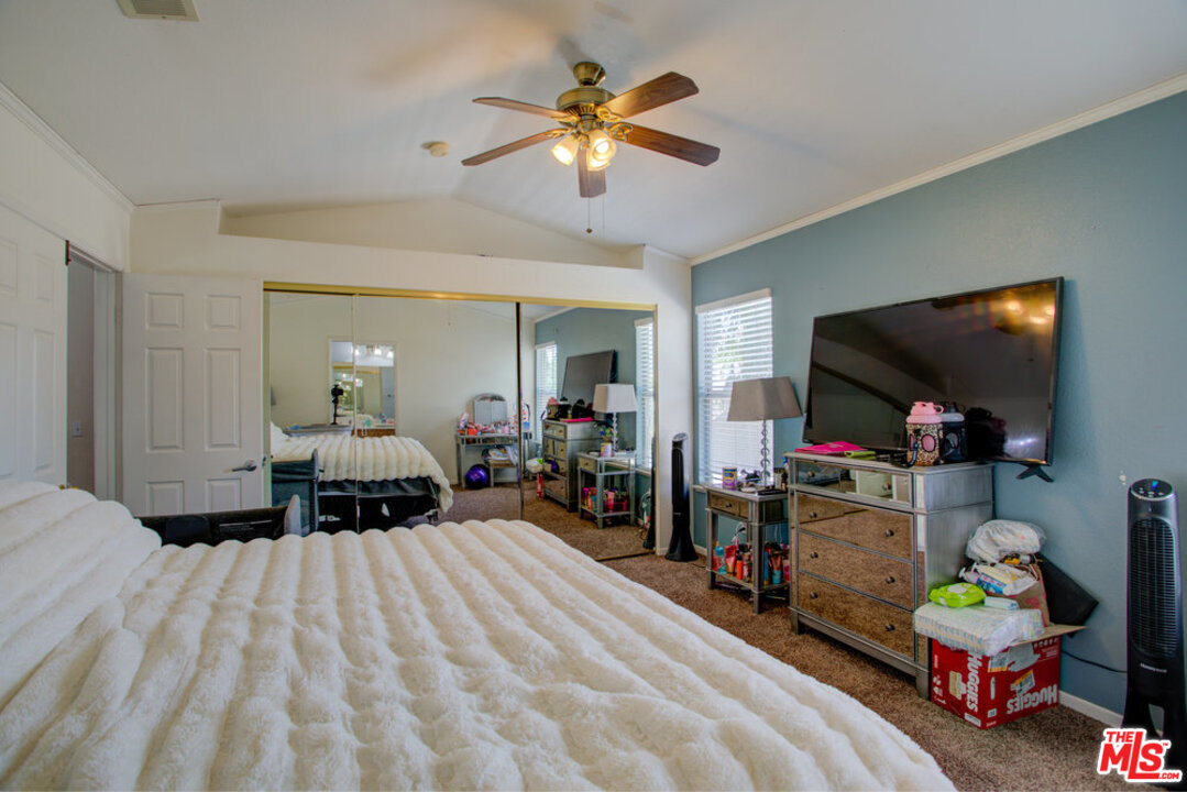 19281 Foxtail Lane Riverside, CA 92508 - Photo 35 of 53 a bedroom with bed and a flat tv screen on dresser