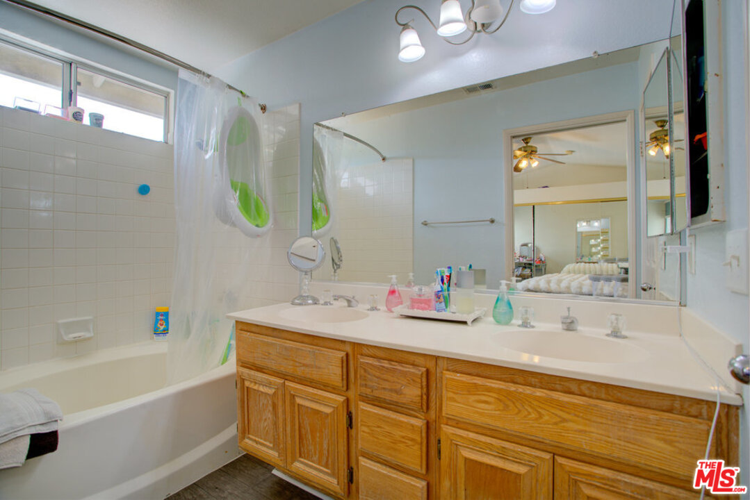 19281 Foxtail Lane Riverside, CA 92508 - Photo 36 of 53 a bathroom with a tub sink and mirror