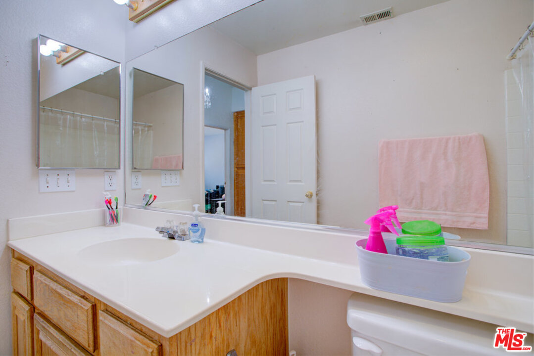 19281 Foxtail Lane Riverside, CA 92508 - Photo 39 of 53 a bathroom with a sink vanity and a mirror