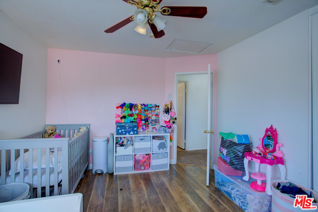 19281 Foxtail Lane Riverside, CA 92508 - Photo 42 of 53 a bedroom with furniture and a wooden floor