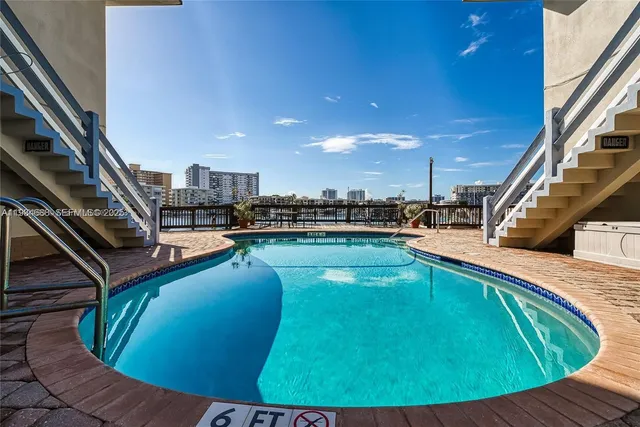 a view of a swimming pool with seating area