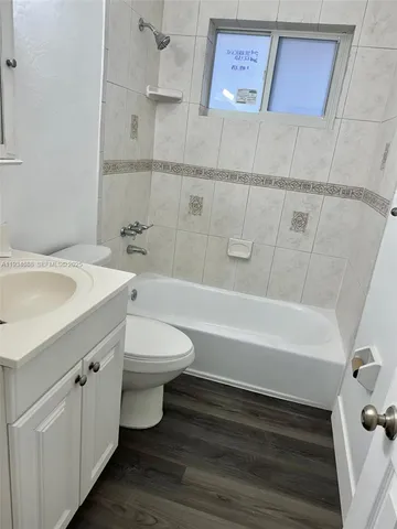 a bathroom with a sink a toilet and bathtub