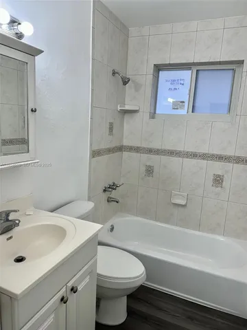 a bathroom with a sink toilet and bathtub