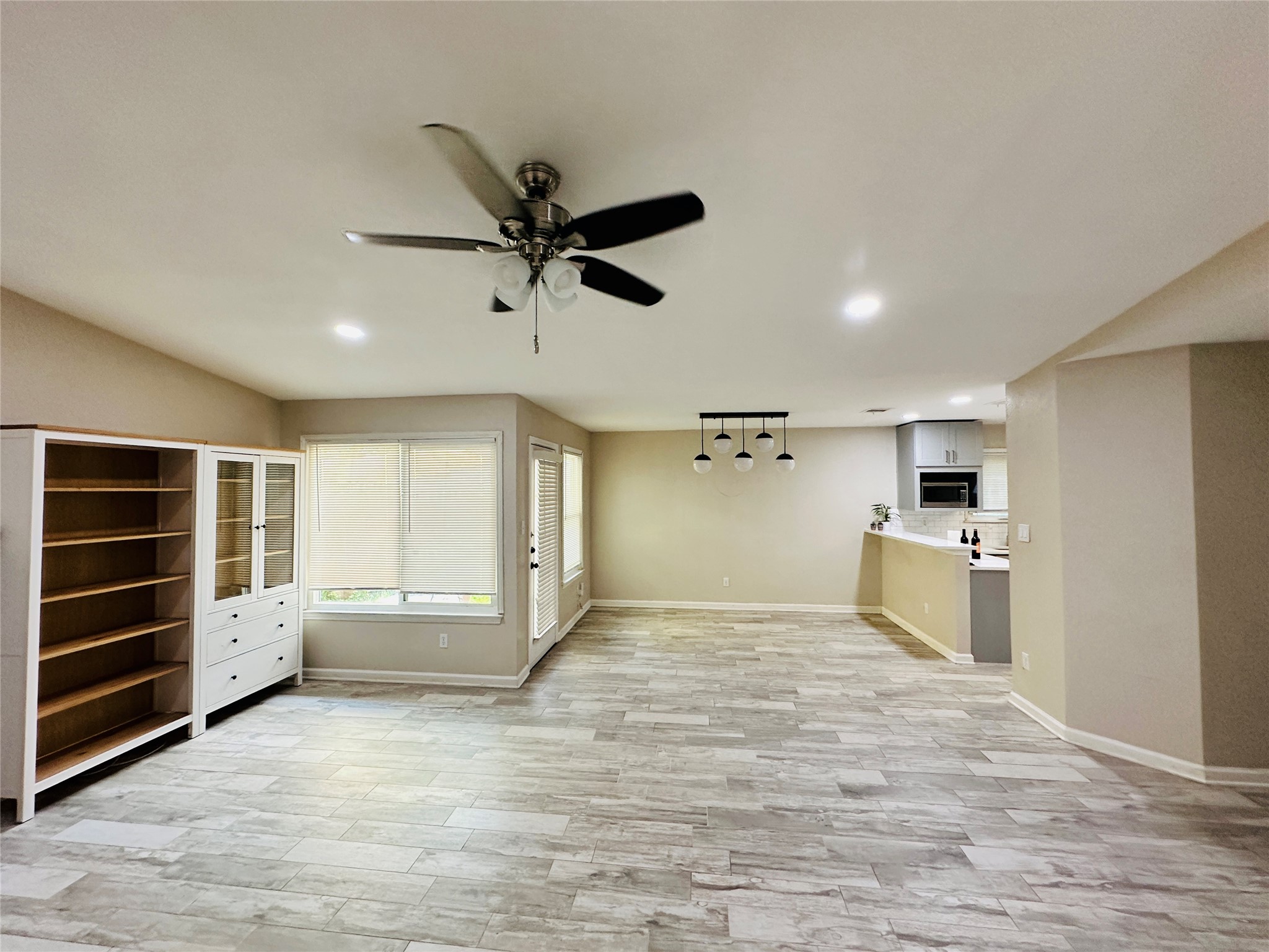 13015 Garfield Lane Austin, TX 78727 - Photo 12 of 16 Unfurnished living room with light wood finished floors, recessed lighting, and a ceiling fan