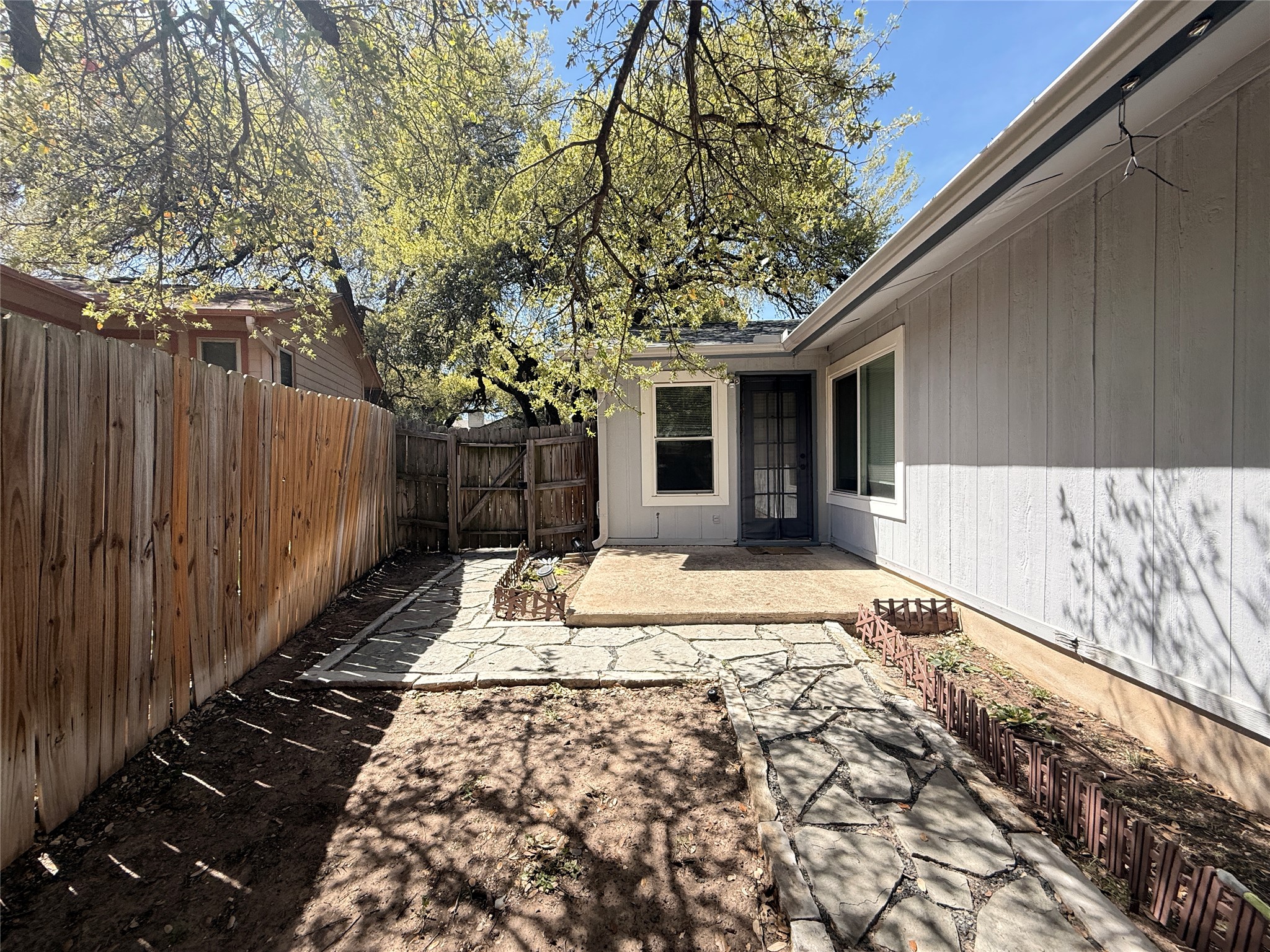 13015 Garfield Lane Austin, TX 78727 - Photo 15 of 16 Fenced backyard featuring a gate and a patio area