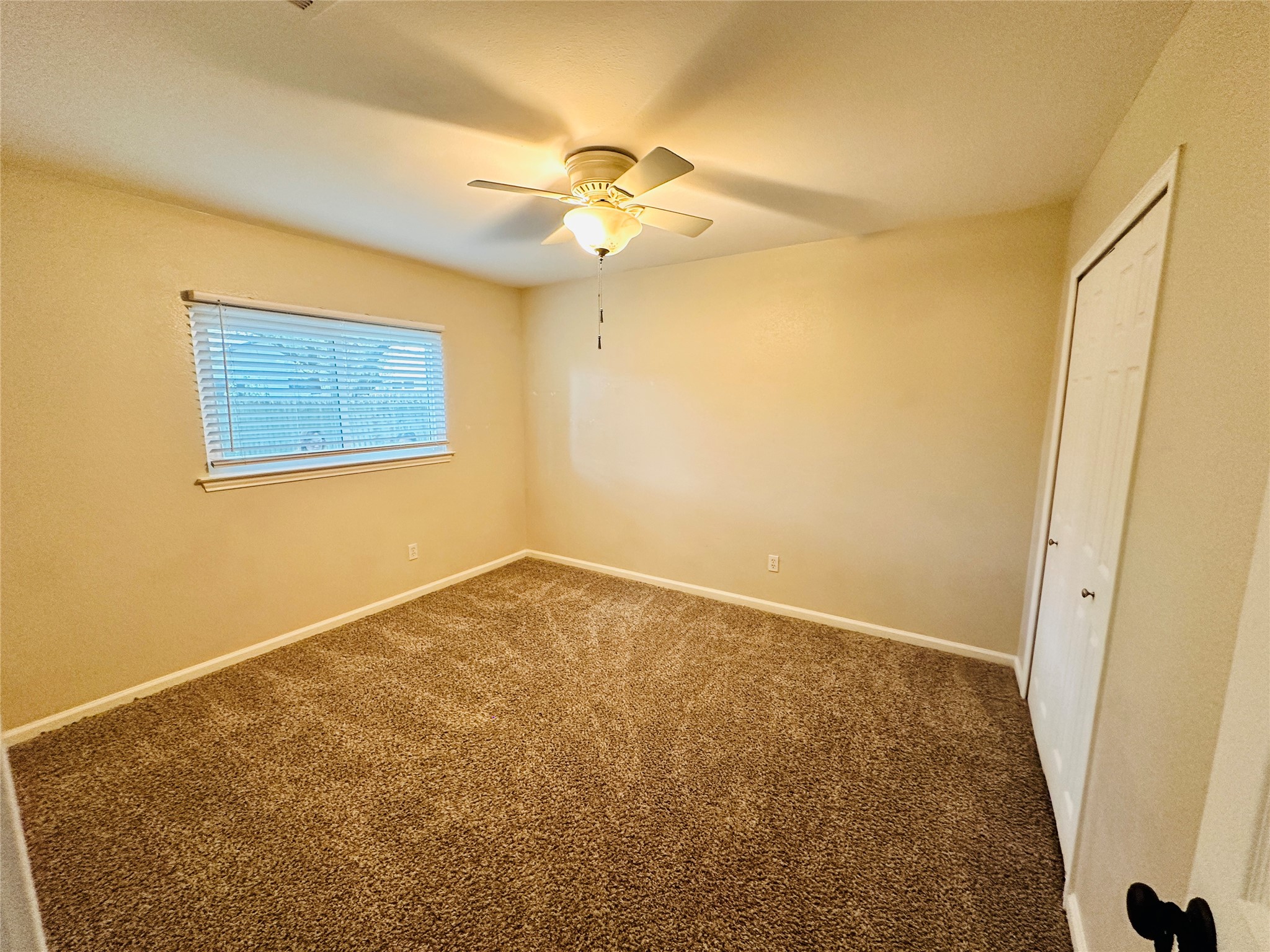 13015 Garfield Lane Austin, TX 78727 - Photo 10 of 16 Unfurnished bedroom featuring a closet, carpet floors, and ceiling fan