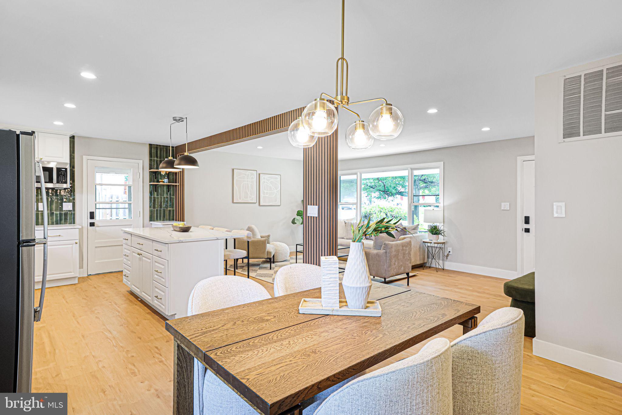 12300 La Plata Street Silver Spring, MD 20904 - Photo 13 of 45 a dining room with wooden floor a chandelier a wooden table and chairs