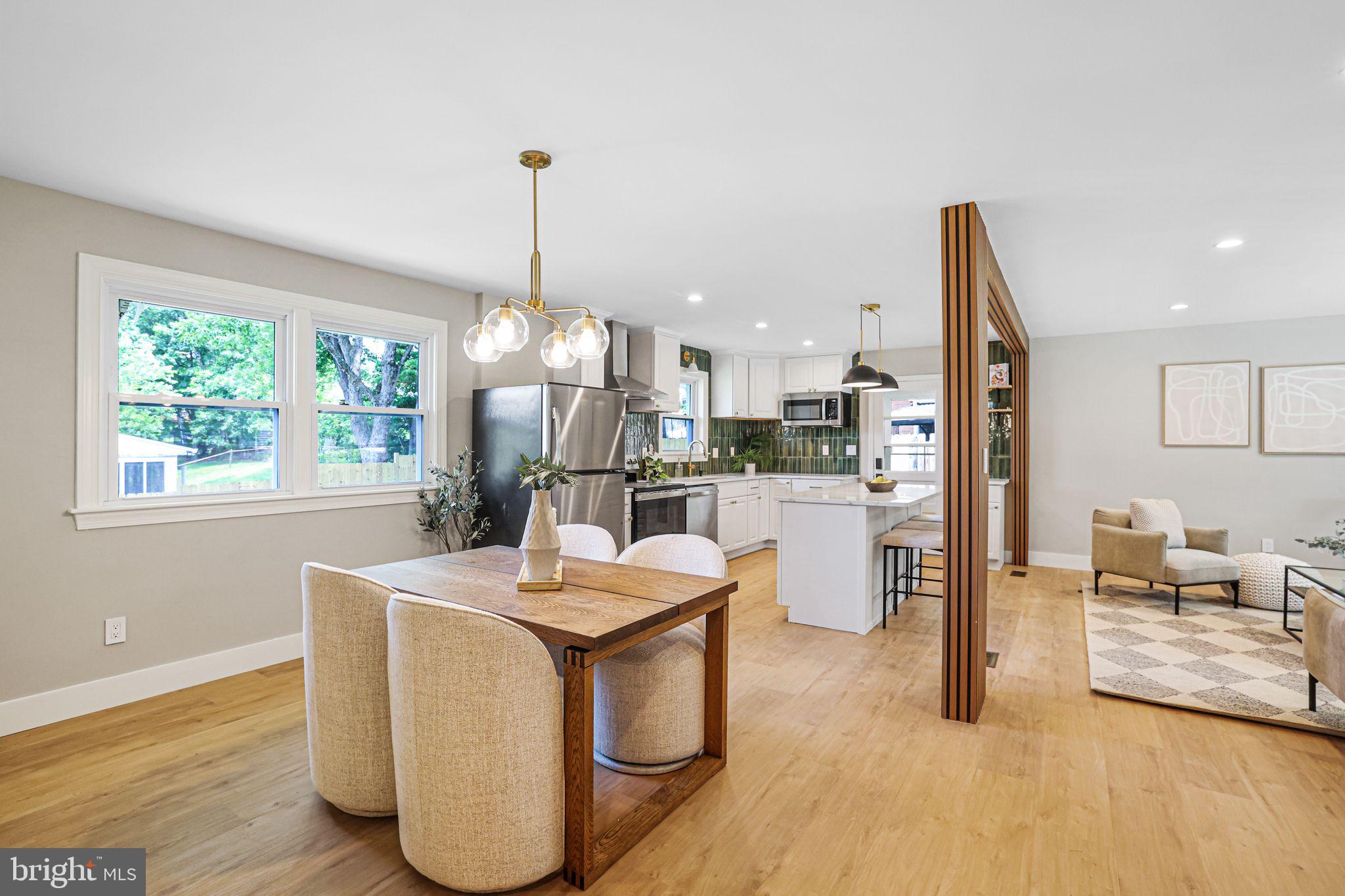 12300 La Plata Street Silver Spring, MD 20904 - Photo 14 of 45 a room with stainless steel appliances kitchen island granite countertop a refrigerator a sink a stove and white cabinets with wooden floor