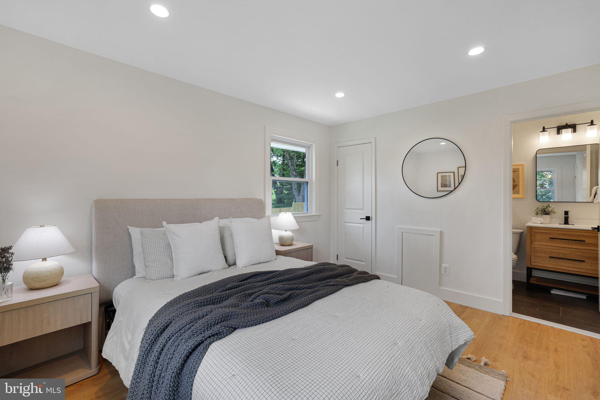 12300 La Plata Street Silver Spring, MD 20904 - Photo 18 of 45 a bedroom with a bed a mirror and lamp