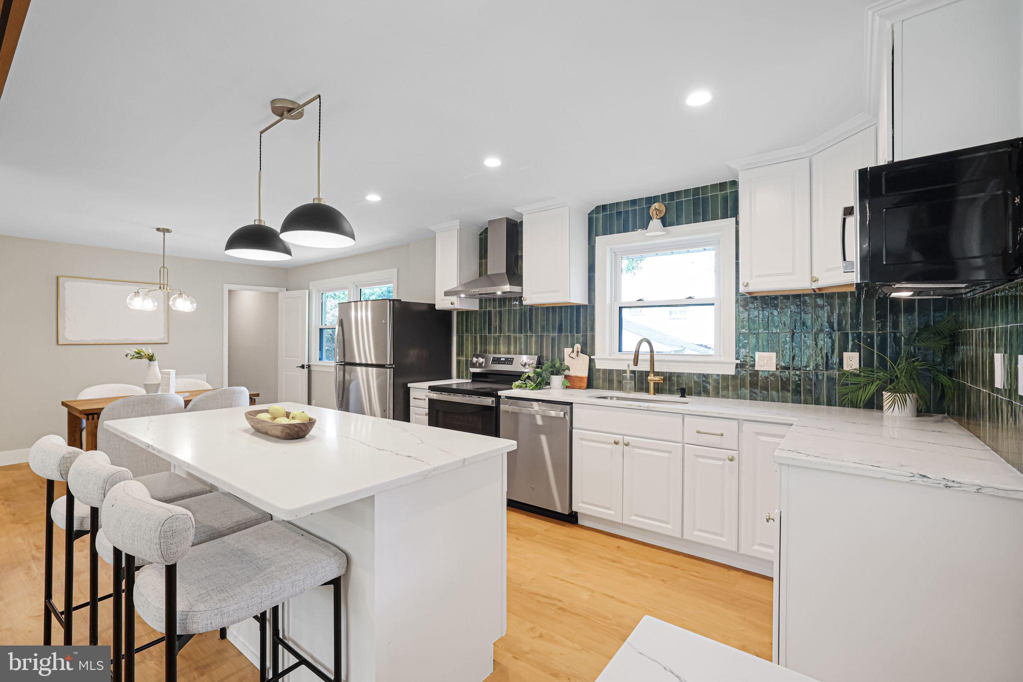 12300 La Plata Street Silver Spring, MD 20904 - Photo 3 of 45 a kitchen with stainless steel appliances kitchen island granite countertop a sink a stove a dining table and chairs