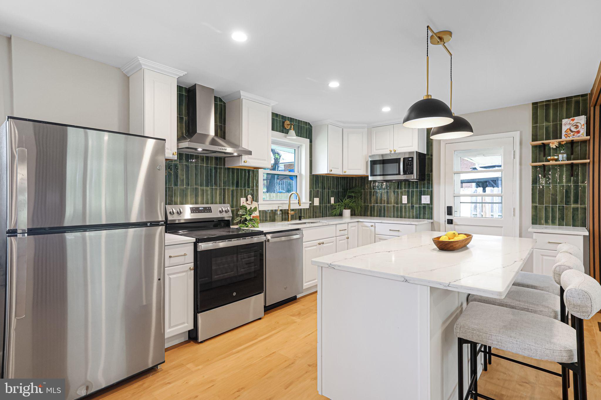 12300 La Plata Street Silver Spring, MD 20904 - Photo 4 of 45 a kitchen with stainless steel appliances a refrigerator a stove a sink a dining table and chairs