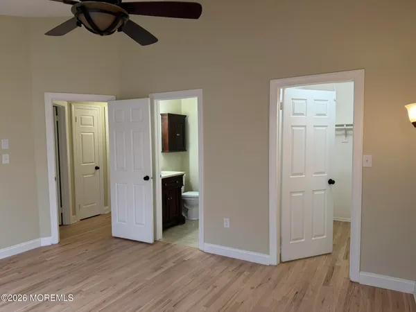 a view of an empty room with closet and a window