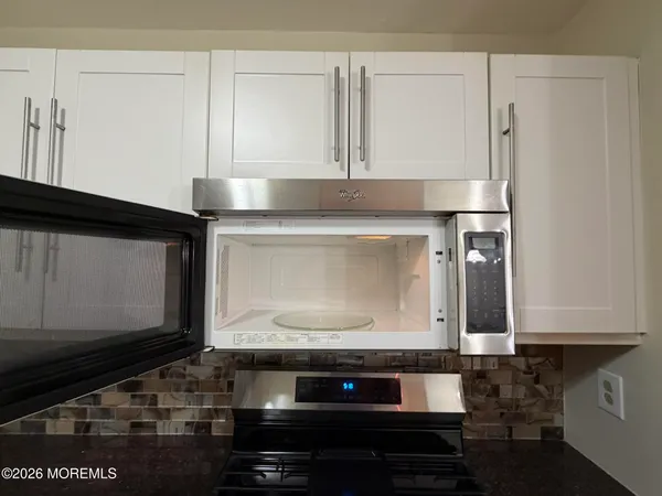 a bathroom with a stove and a microwave