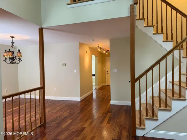 a view of an entryway with wooden floor