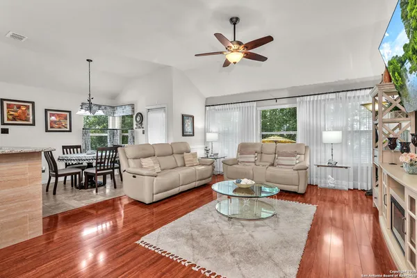 a living room with furniture and a chandelier