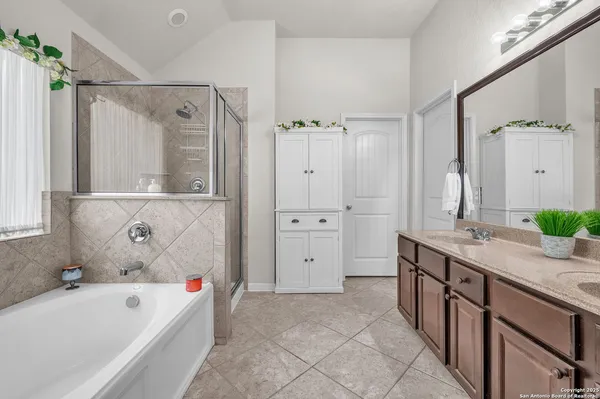 a bathroom with a tub sink and mirror