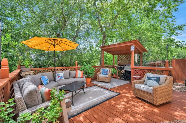 an outdoor sitting area with furniture and garden view