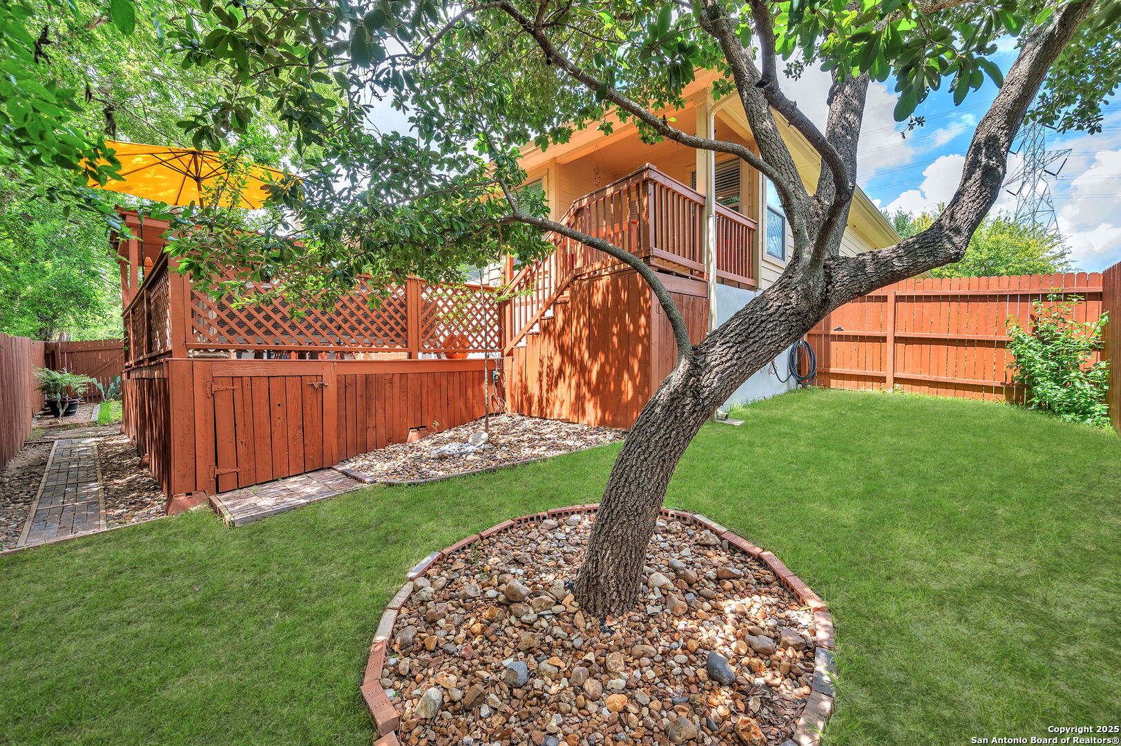 5809 Devonwood Street Schertz, TX 78108 - Photo 25 of 26 a view of a backyard with wooden fence