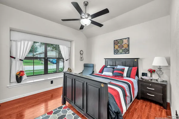 a bedroom with a bed and a large window