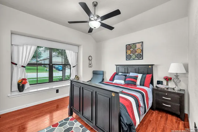 a bedroom with a bed and a large window