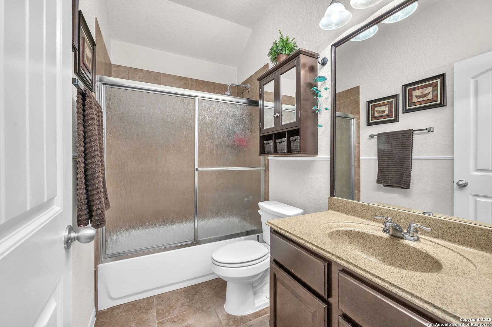 5809 Devonwood Street Schertz, TX 78108 - Photo 7 of 26 a bathroom with a granite countertop sink toilet and shower