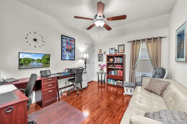 a living room with furniture and wooden floor