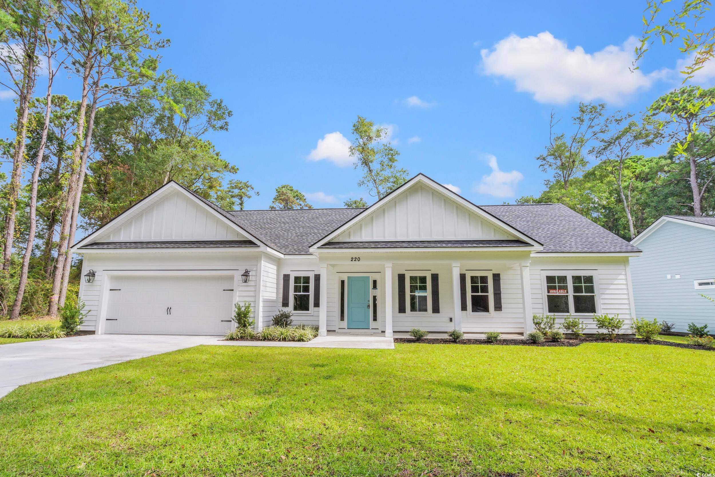 220 Ford Road Pawleys Island, SC 29585 - Photo 1 of 18 View of front of house with board and batten siding, a porch, and a shingled roof