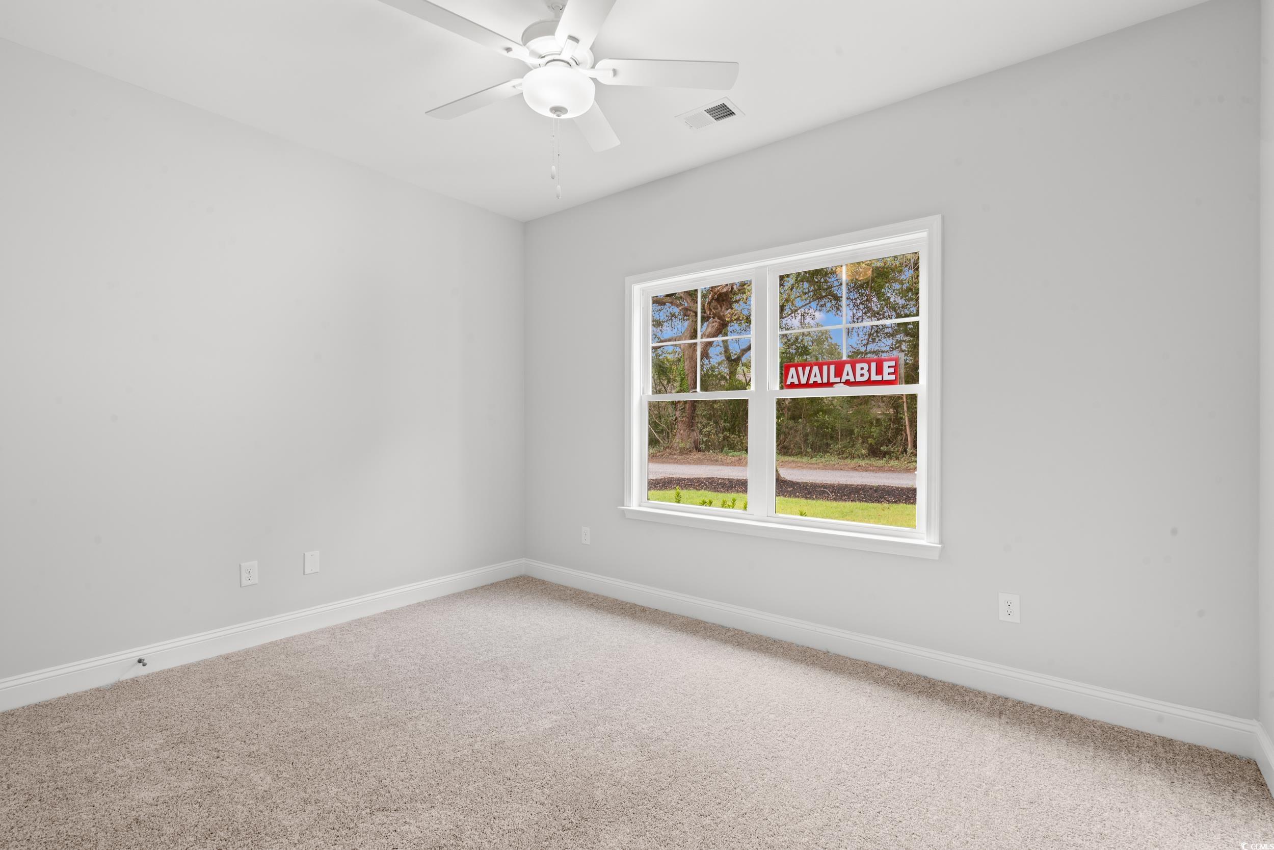 220 Ford Road Pawleys Island, SC 29585 - Photo 12 of 18 Empty room featuring carpet floors and a ceiling fan
