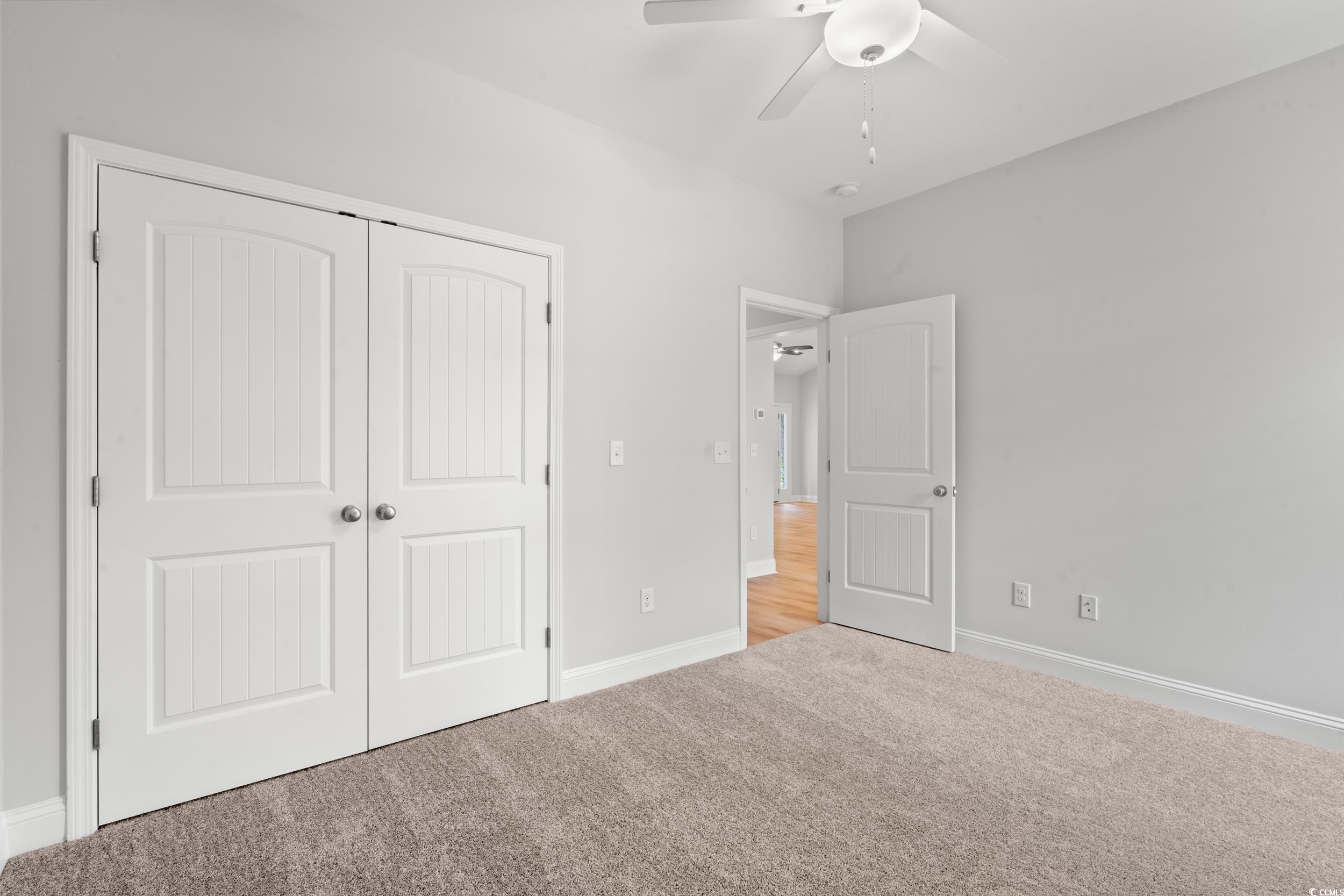 220 Ford Road Pawleys Island, SC 29585 - Photo 13 of 18 Unfurnished bedroom with carpet flooring, a closet, and a ceiling fan