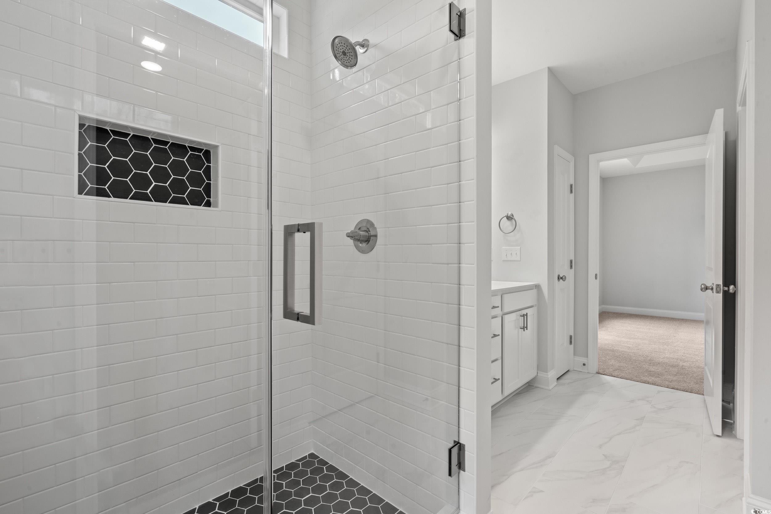 220 Ford Road Pawleys Island, SC 29585 - Photo 6 of 18 Full bathroom with a shower stall, vanity, and light marble finish floors