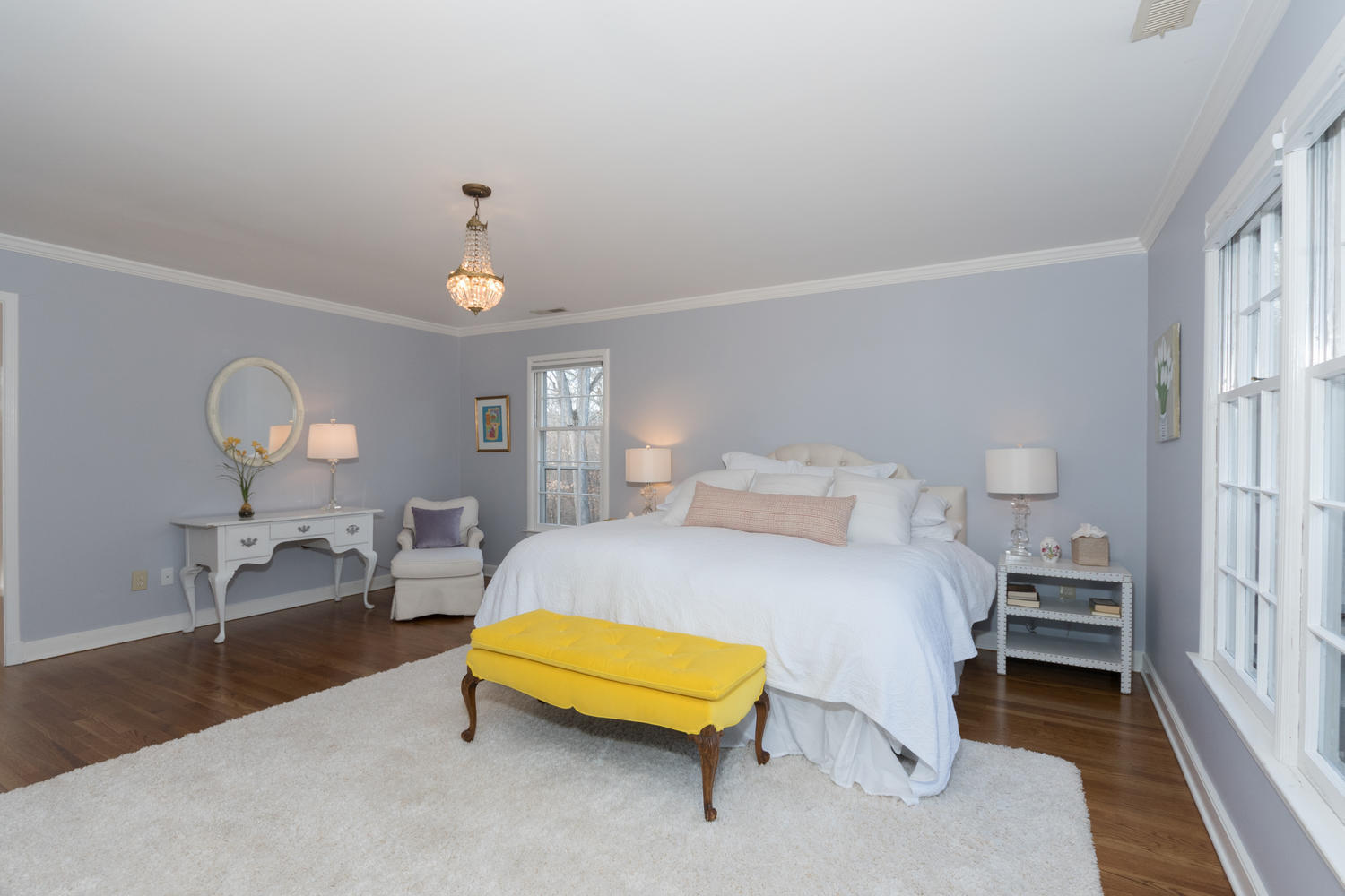 7 Hunt Road Darien, CT 06820 - Photo 21 of 40 a bedroom with a bed couch chandelier and a window