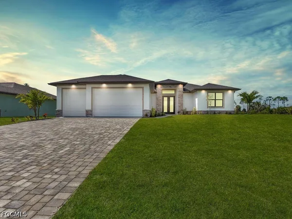 a front view of a house with a yard and garage