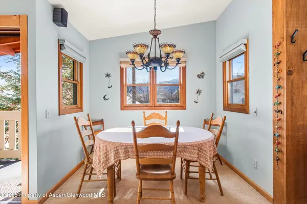 a view of a dining room with furniture and window