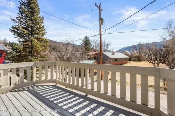 a view of a balcony with wooden floor