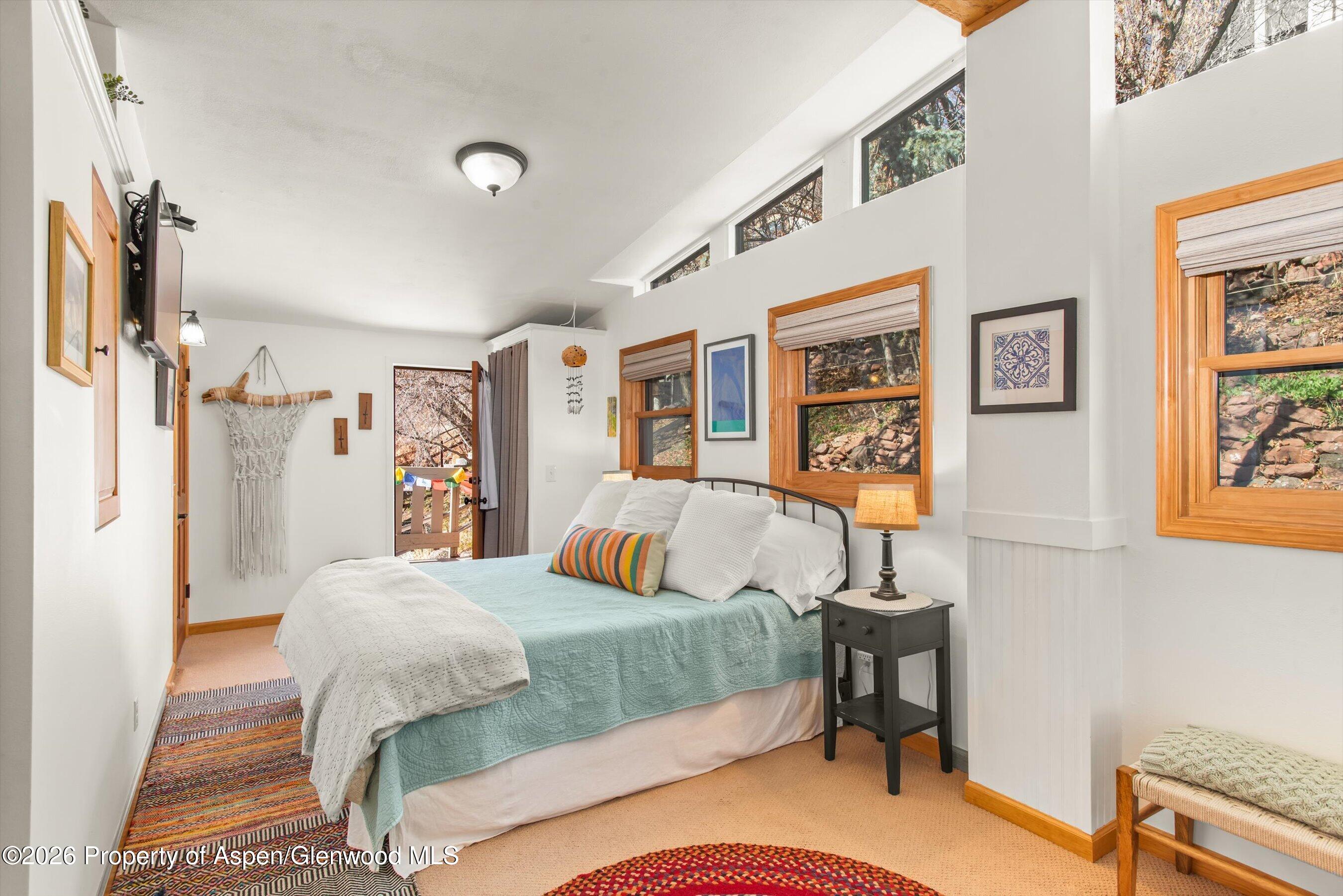 120 Tucker Lane Basalt, CO 81621 - Photo 19 of 33 a bedroom with a bed and wooden floor
