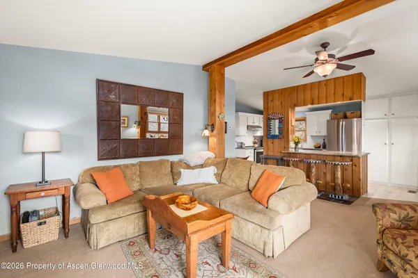 a living room with furniture and a lamp